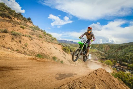 dirt biker riding offroad in the mountains
