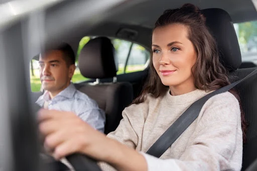 person driving a car with a passenger