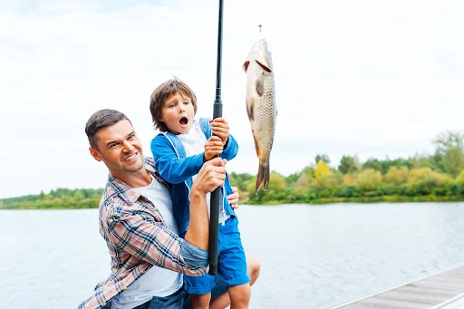 Parent and kid fishing in an Arizona lake.