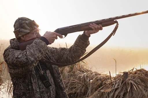 person hunting with shotgun