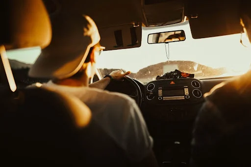 person driving at sunset