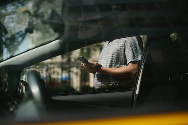 Person inspecting a used car for purchase